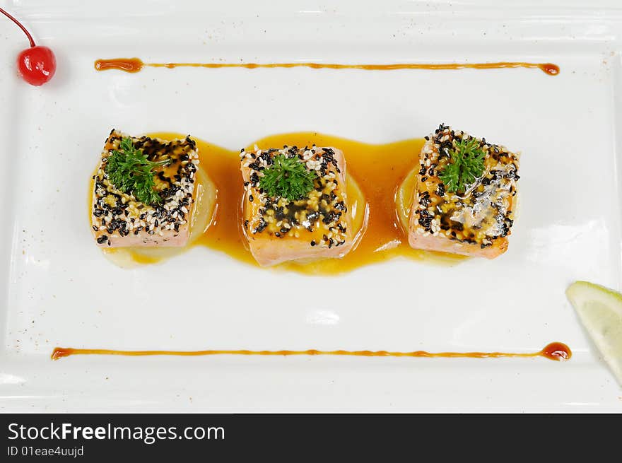 A fish restaurant row on white dish. A fish restaurant row on white dish