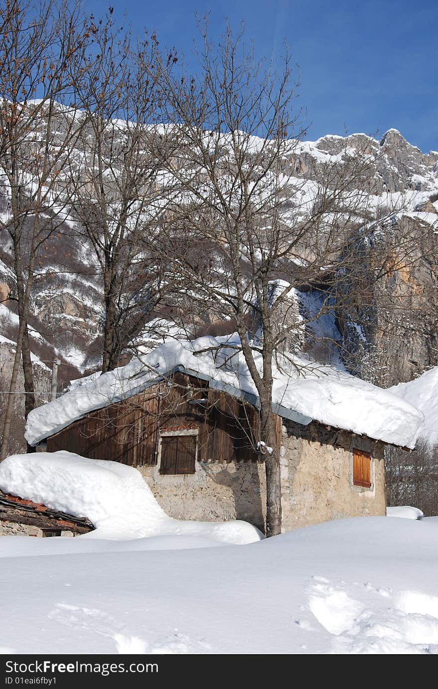 An isolated chalet during a strong cold winter in italian alps. An isolated chalet during a strong cold winter in italian alps