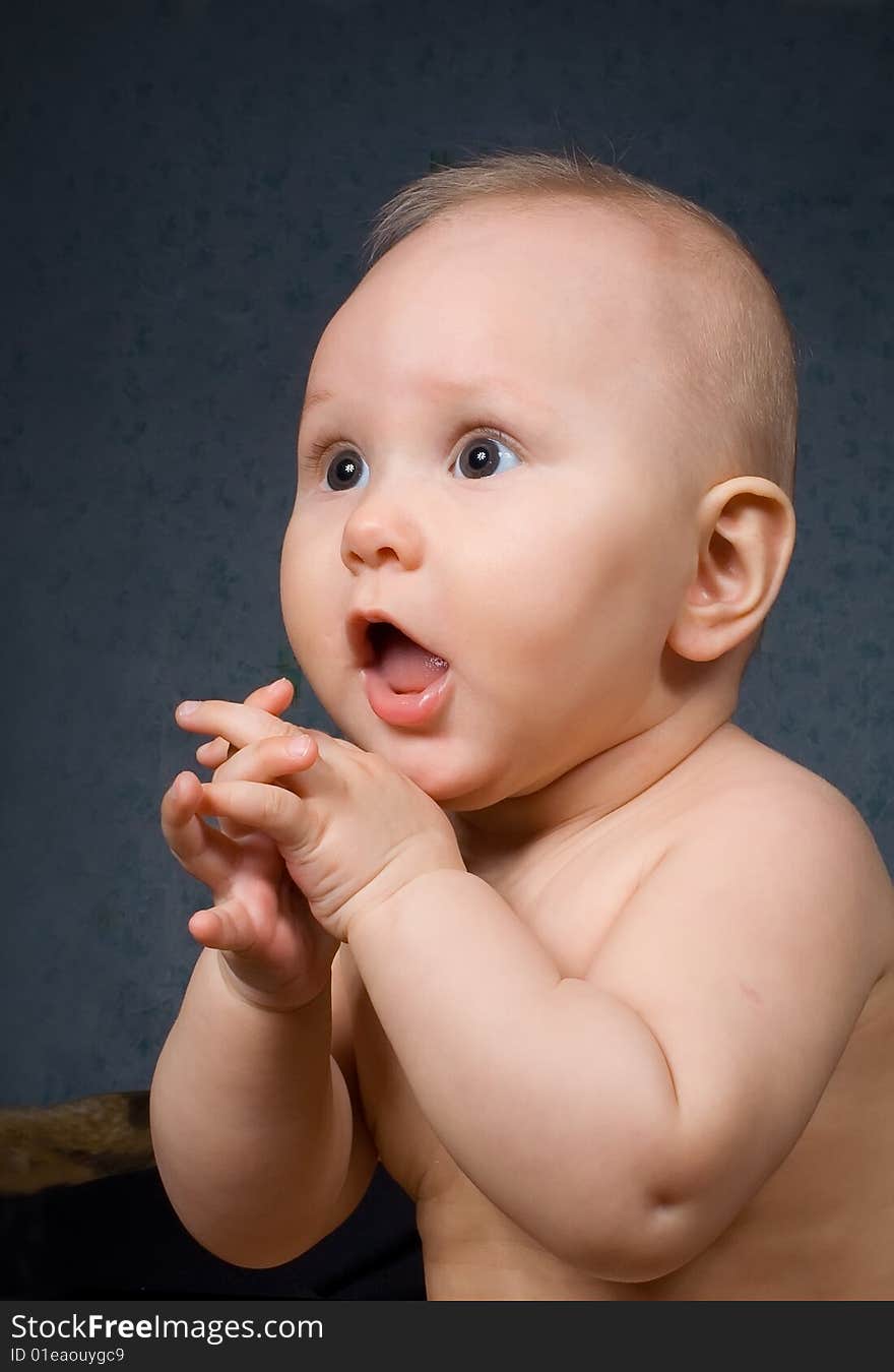 Child with raise hand on gray background. Child with raise hand on gray background