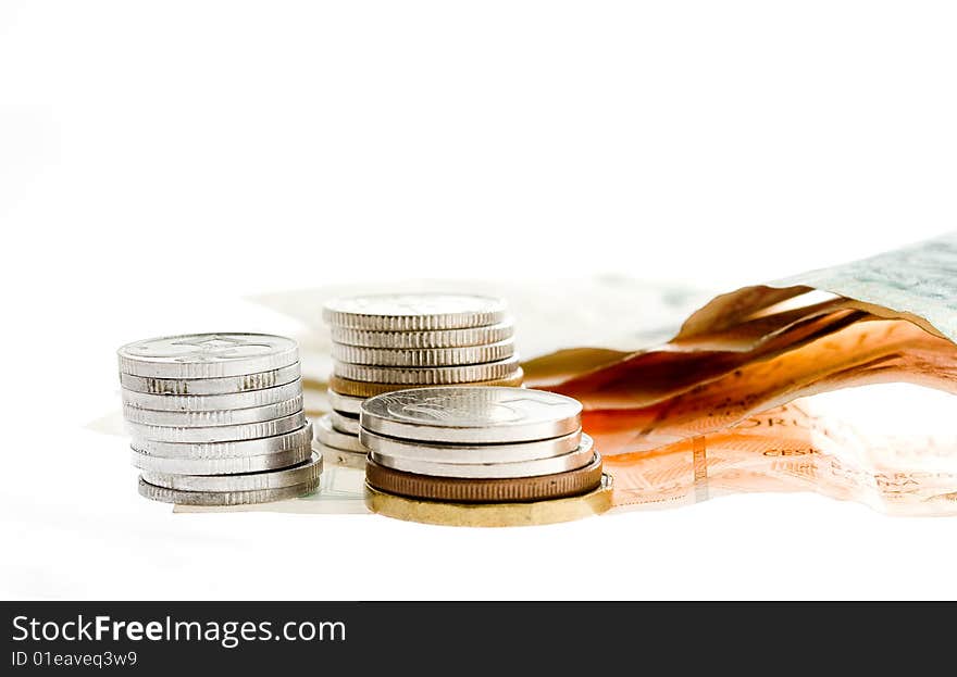 Czech bank notes and coins on white background