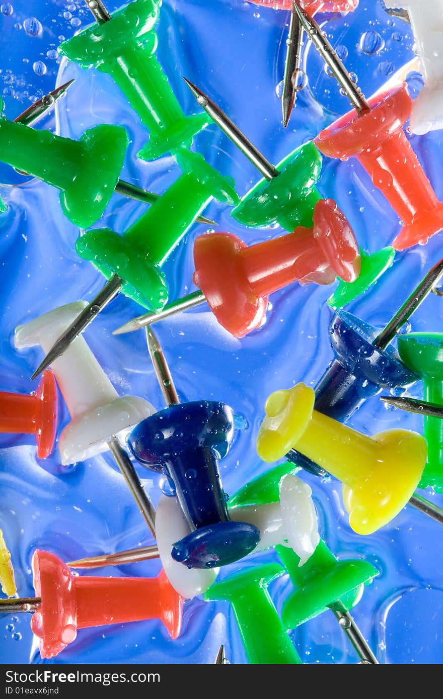 Colorful thumbtacks with some bubbles