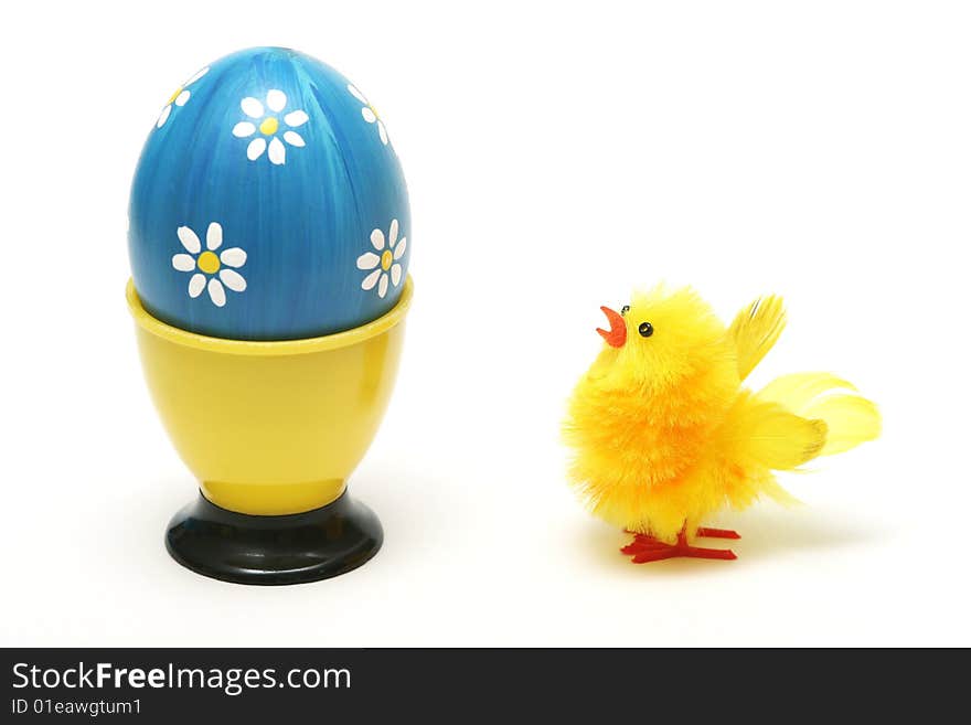 Easter chick and easter blue egg with white flower on white background.