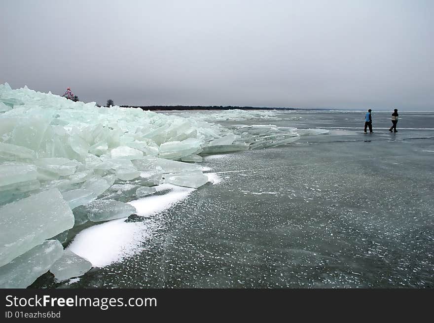 Iceberg with walking people in Peipsi lake in Estonia