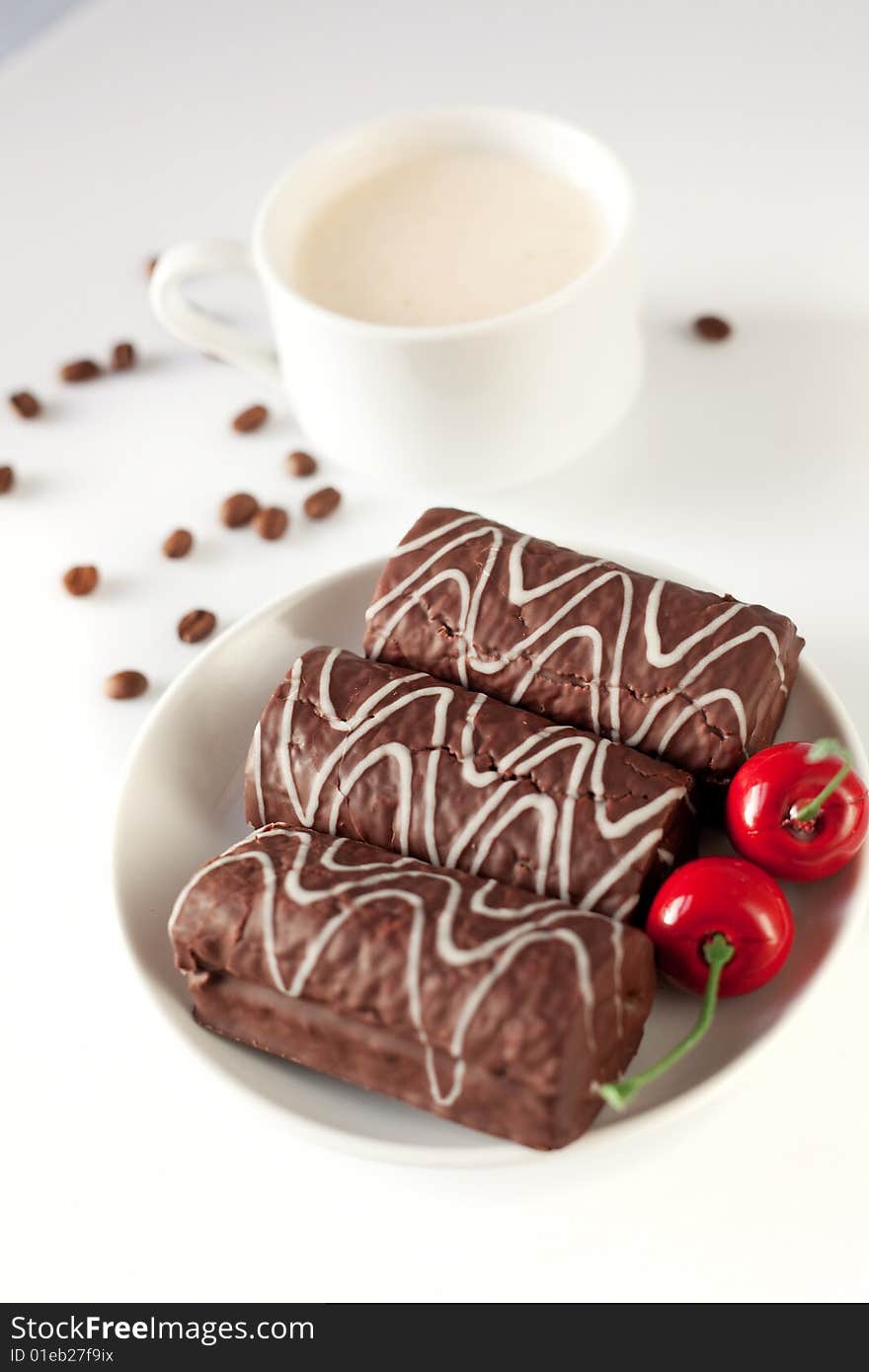 Chocolate cakes with cup of milk and cherries