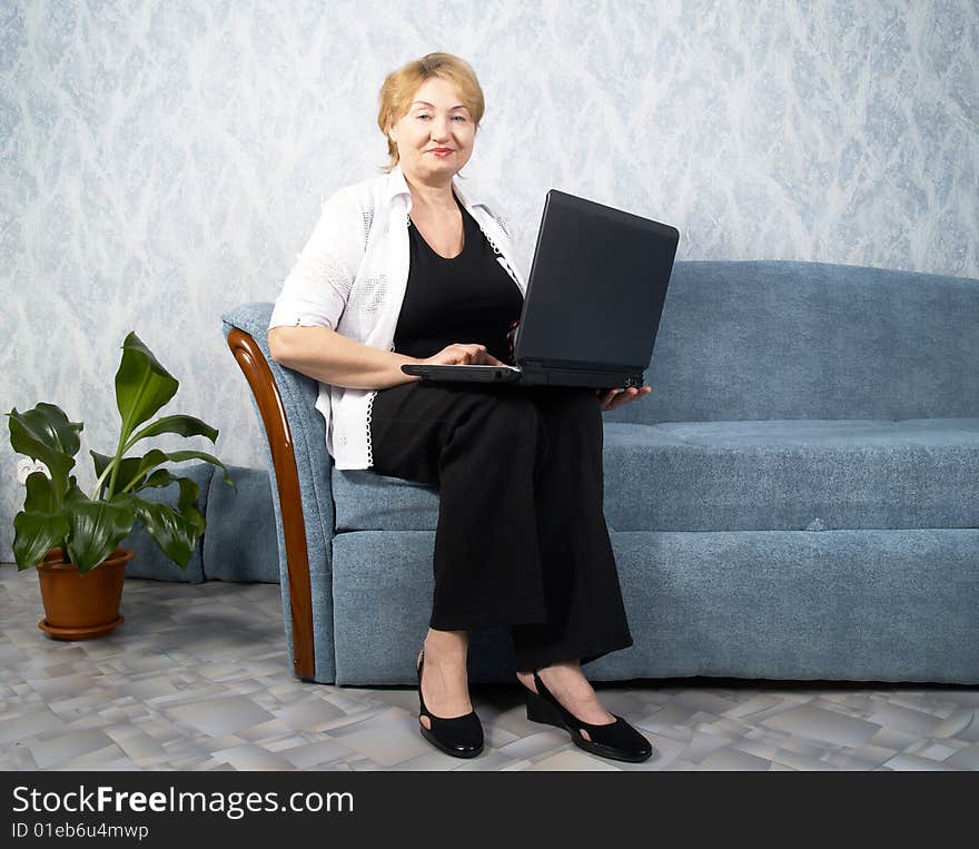 The business mature woman with a laptop. The business mature woman with a laptop