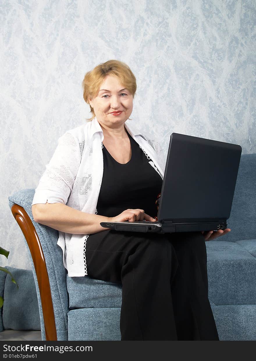 The business mature woman with a laptop. The business mature woman with a laptop