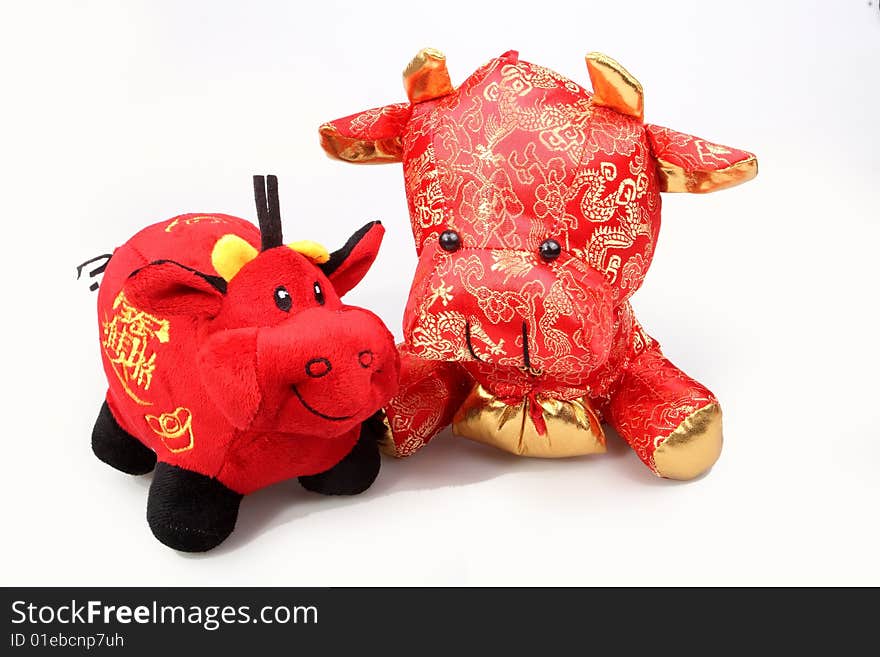 Two Chinese lucky oxen are on white background.So cute.

Chinese characters on the lucky ox has are getting rich.