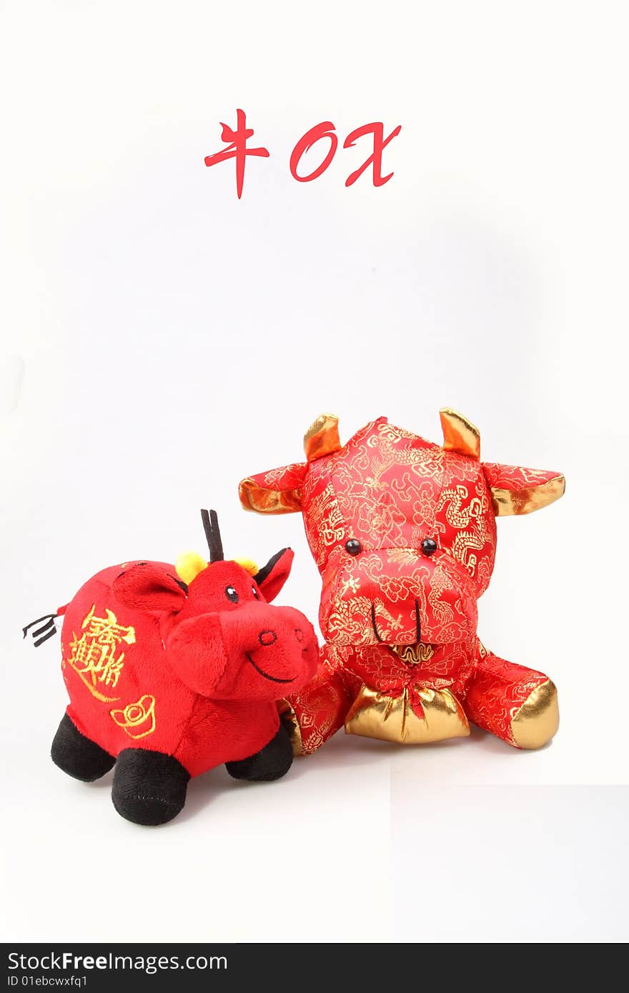 Two Chinese lucky oxen are on white background.So cute. Chinese characters on the lucky ox has are getting rich.