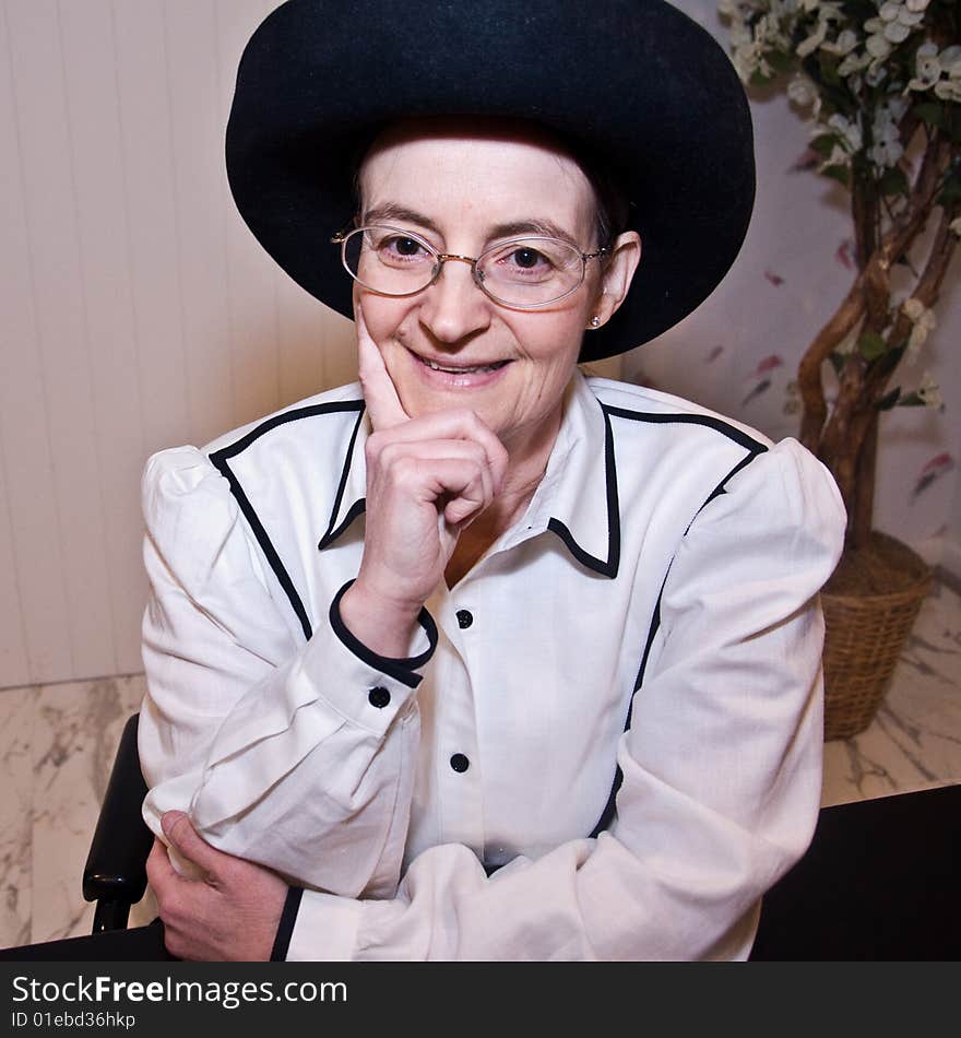 Woman smiling and thinking in 2009, wearing an Oscar de la Renta blouse from 1979.