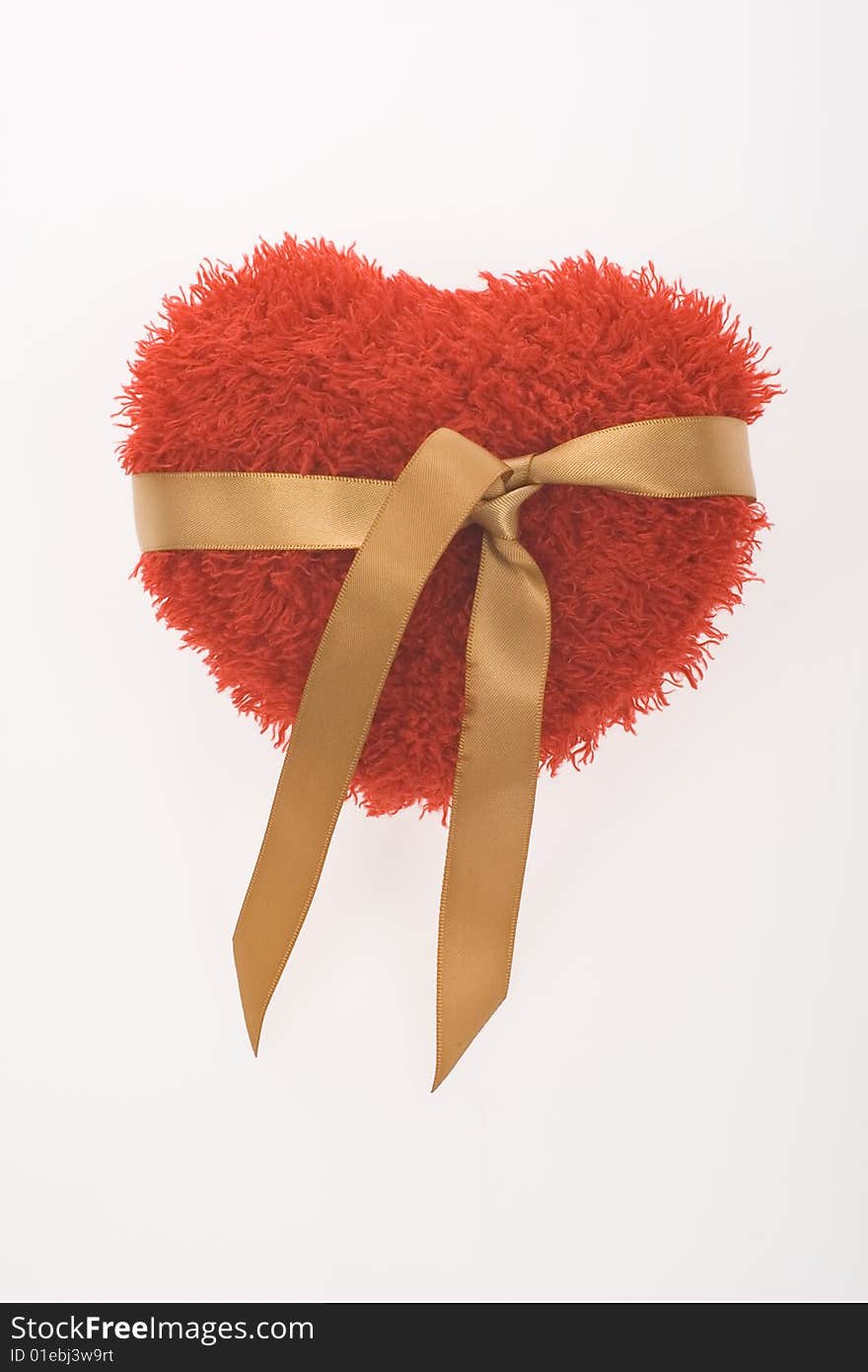 Red fluffy heart with golden ribbon on white background