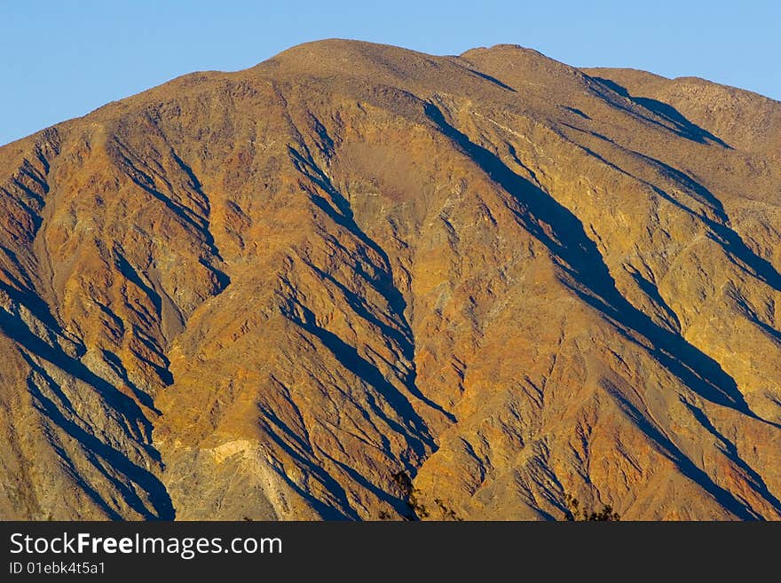 A rust colored hill in the Southern California desert. A rust colored hill in the Southern California desert