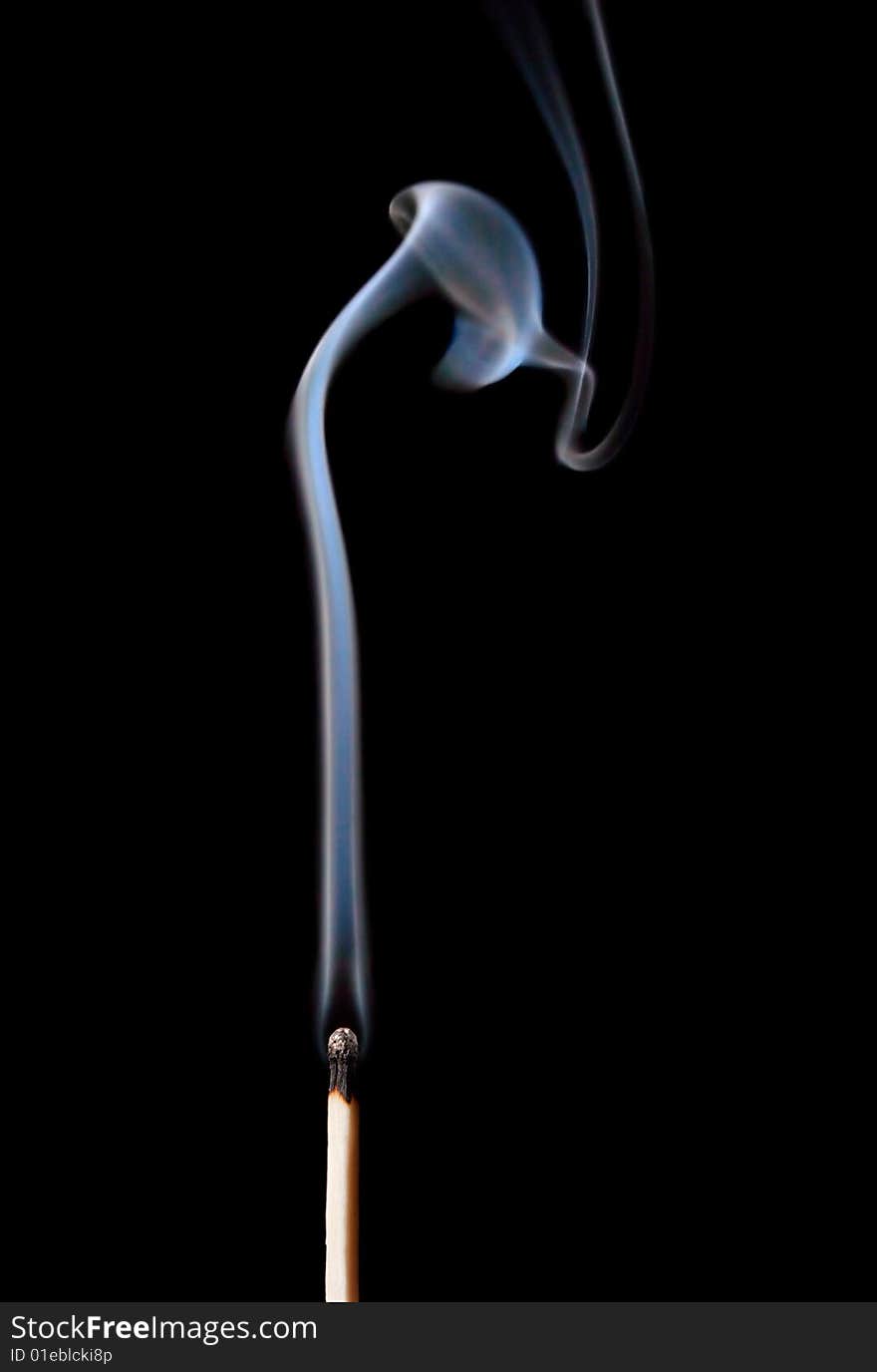 Burnt match with white smoke on black background. Burnt match with white smoke on black background