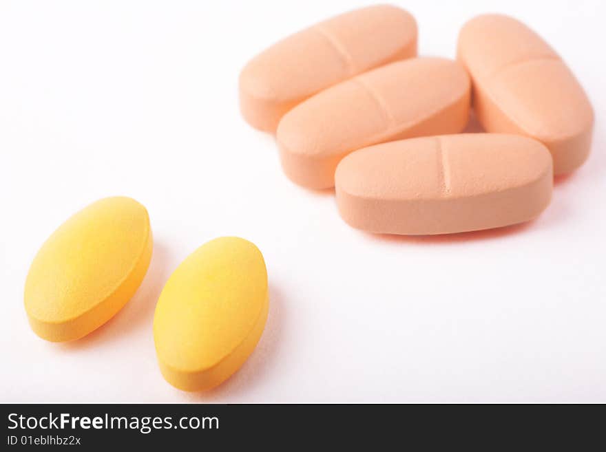 Cloroful pills lying on white background