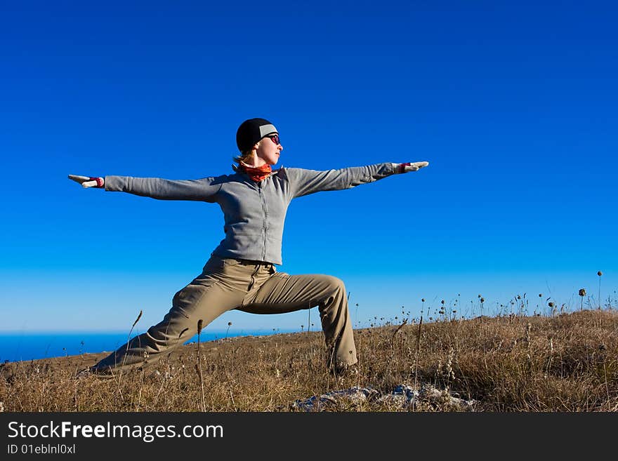 Young woman doing yoga outdoors