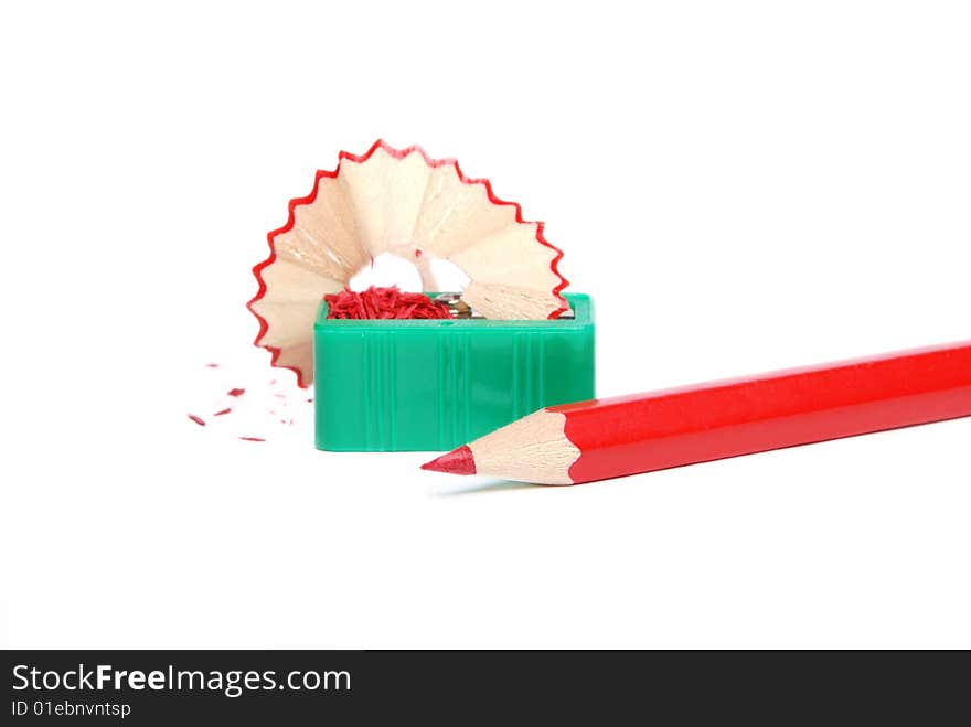 Red pencil and green sharpener on a white background. Red pencil and green sharpener on a white background