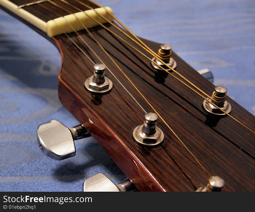 A detail of an acoustic guitar with its strings. A detail of an acoustic guitar with its strings.