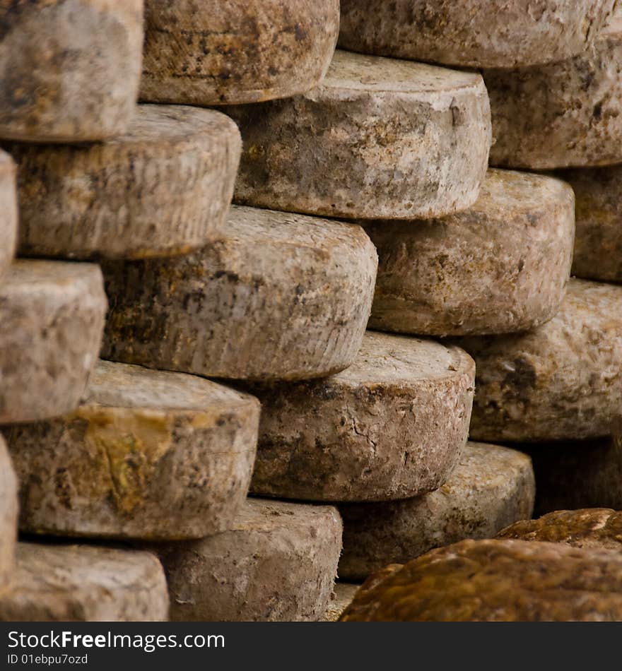 Stack of cheese wheels on a market in southern france. Stack of cheese wheels on a market in southern france