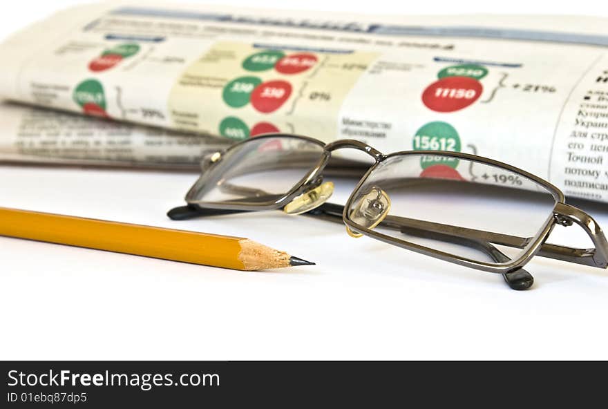 Newspaper and glasses isolated on white background