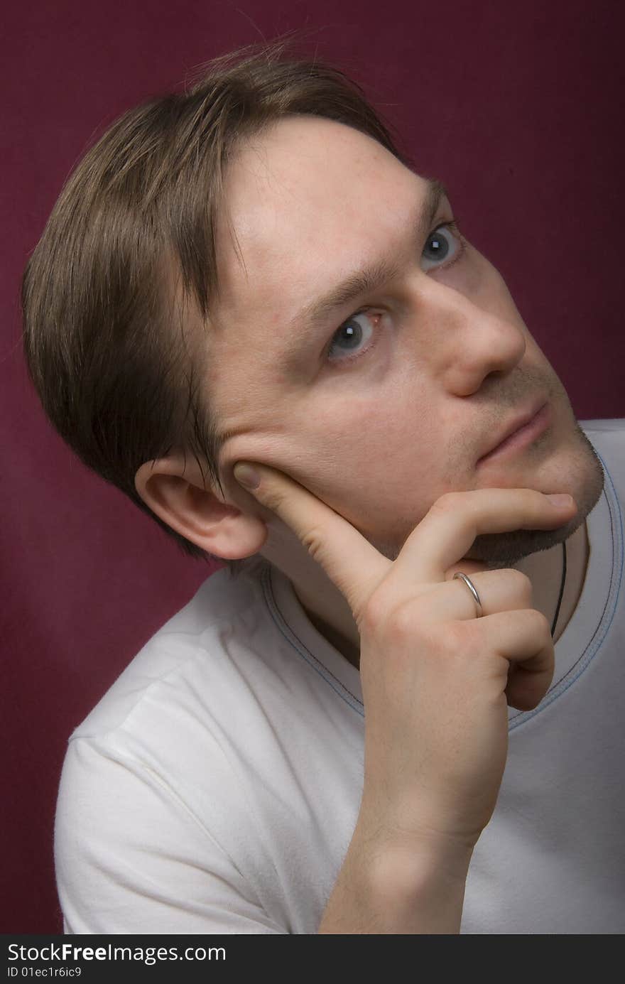 Portrait of a young man on the purple background. Portrait of a young man on the purple background