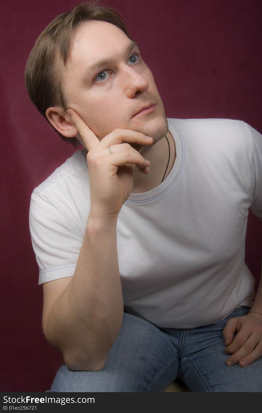 Portrait of a young man on the purple background. Portrait of a young man on the purple background