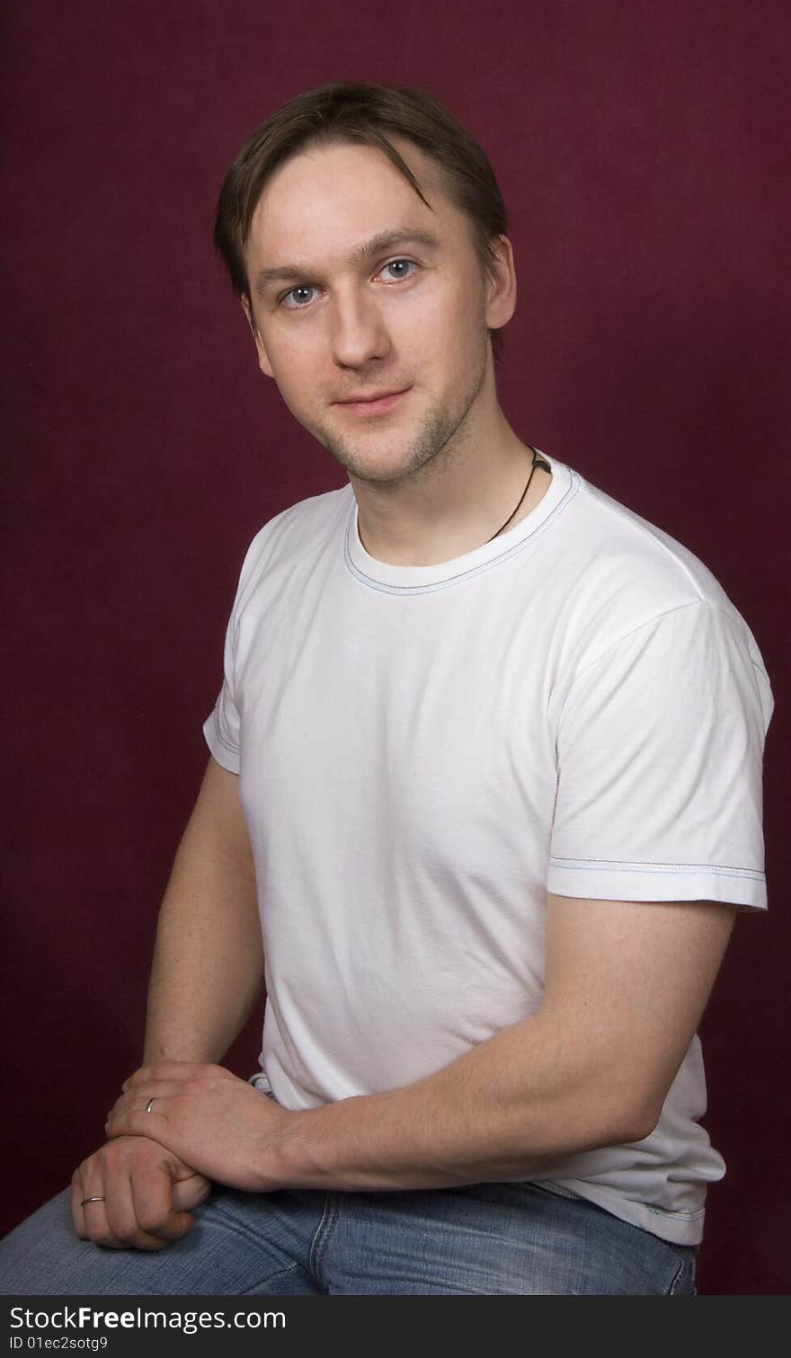 Portrait of a young man on the purple background. Portrait of a young man on the purple background