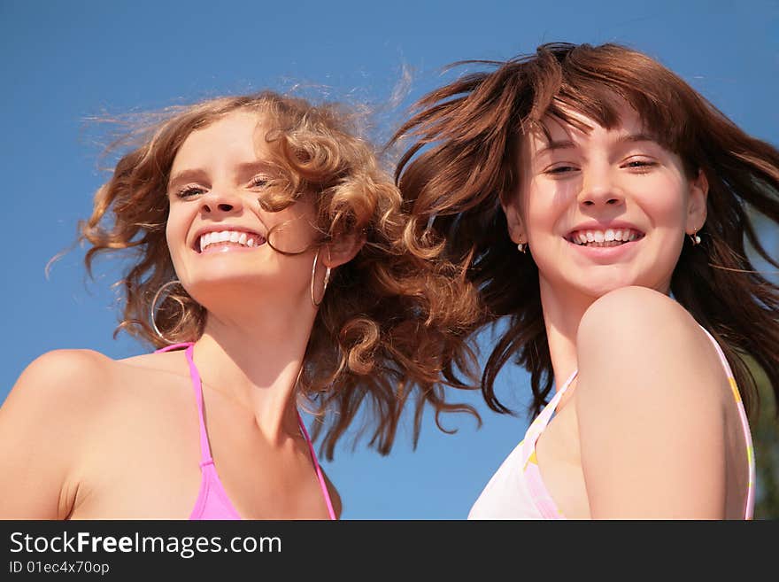 Two girlfriend with windy hairs