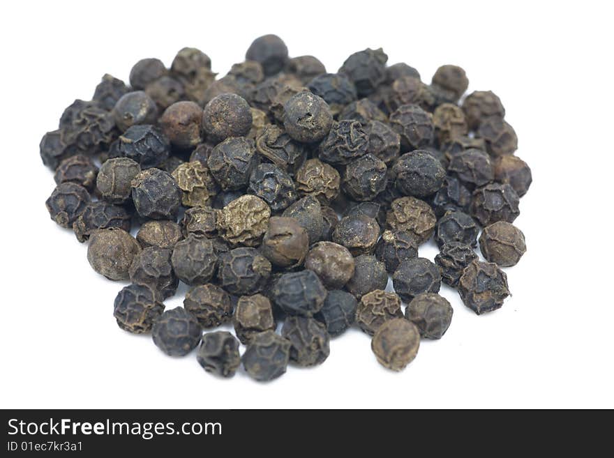 Macro shot of a pile of peppercorns isolated on white