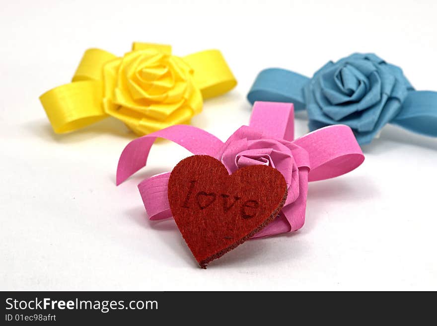 Blue, pink and yellow bows and heart. Blue, pink and yellow bows and heart