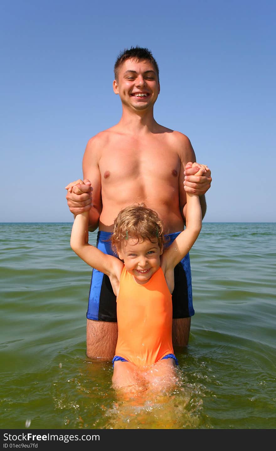 Father with child in sea