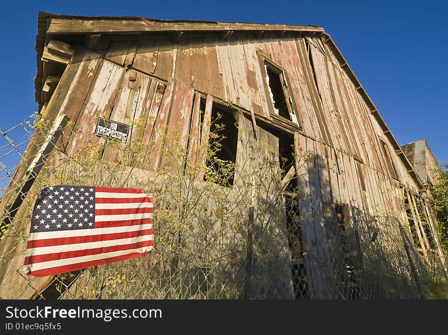 American Flag And Decrepit Building