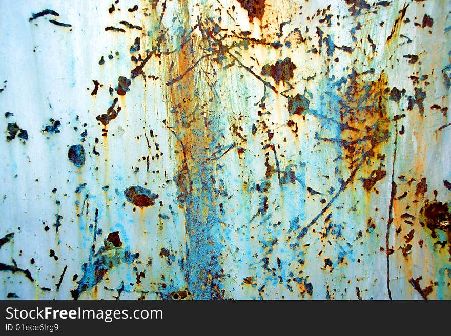 Aging paint on background of the rusty iron fence