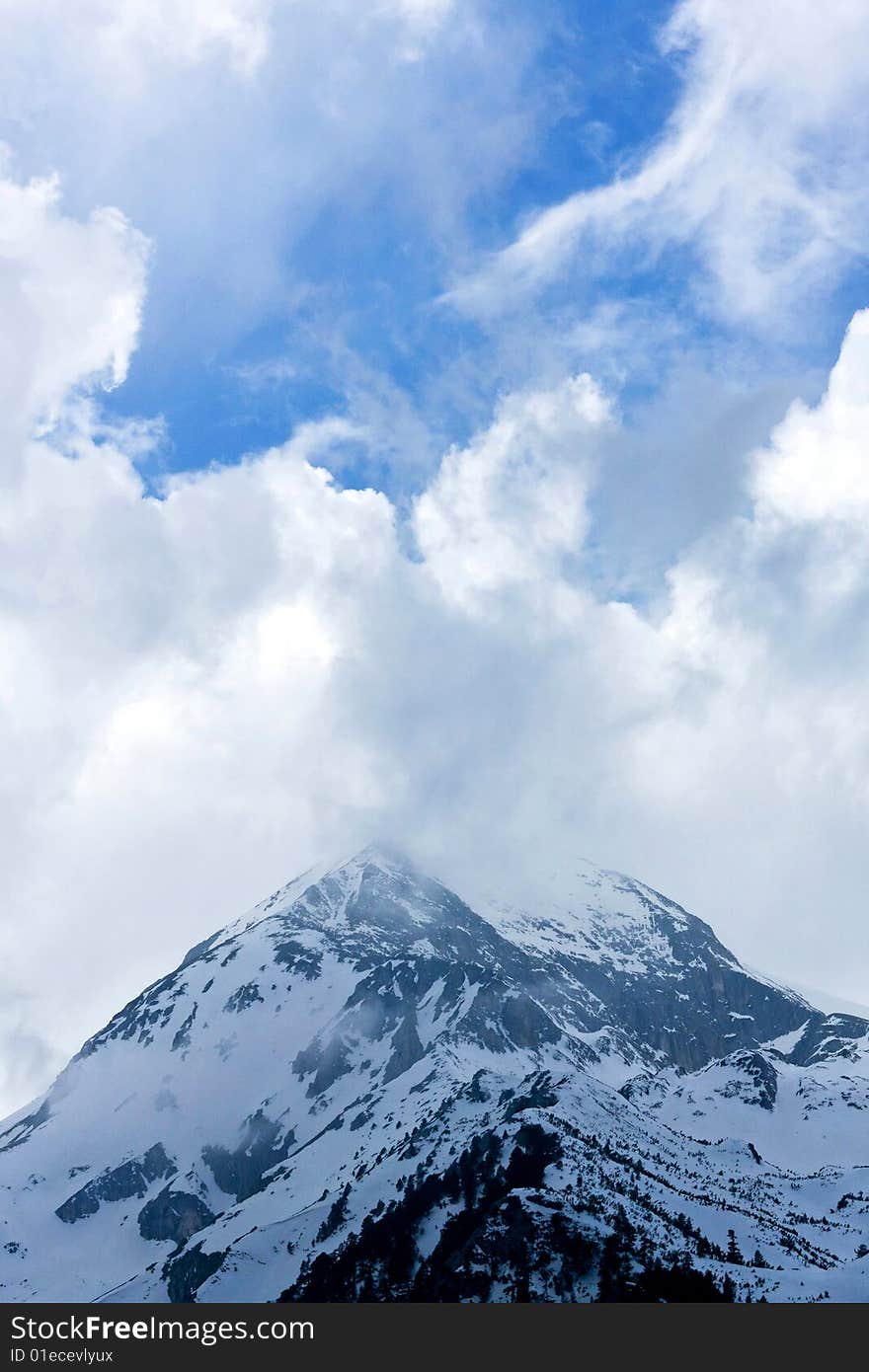 High mountain peak hidden in foggy clouds. High mountain peak hidden in foggy clouds