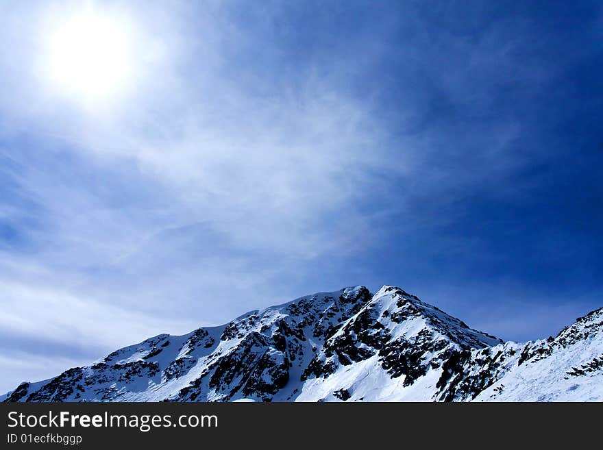 Sun shinning through foggy clouds onto mountains. Sun shinning through foggy clouds onto mountains