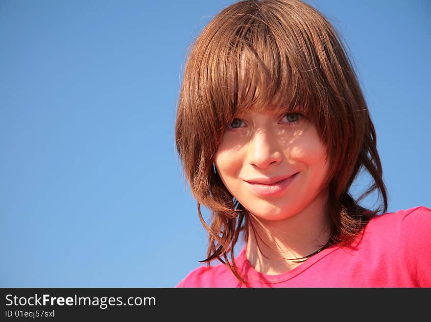 Portrait of young girl on blue sky background