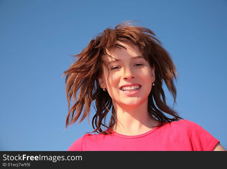 Young girl on blue sky background