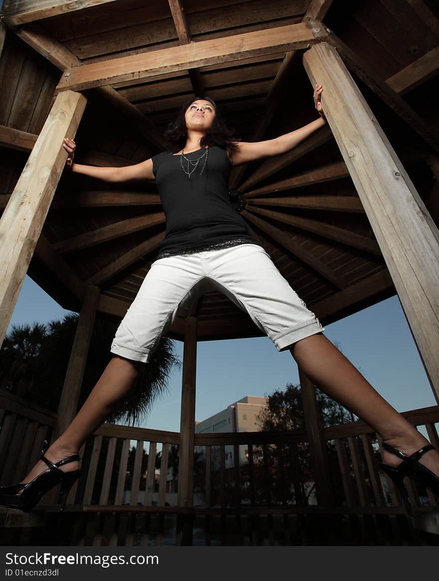 Young woman with her arms and legs extended outward like a spider. Young woman with her arms and legs extended outward like a spider