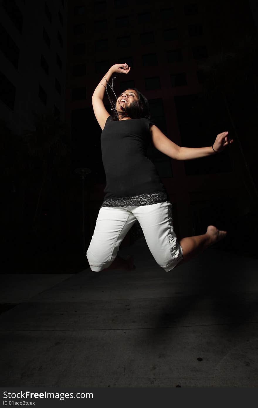 Young woman jumping, show while in midair. Young woman jumping, show while in midair