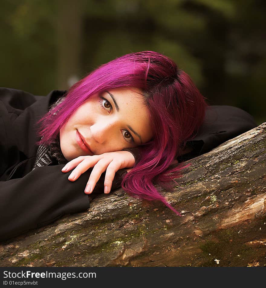 Close-up portrait of a red-haired woman during her walk in a park. Close-up portrait of a red-haired woman during her walk in a park