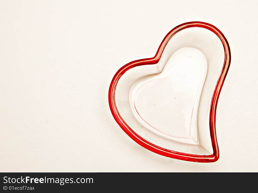 Isolated shot of glass heart shaped container in a white background.