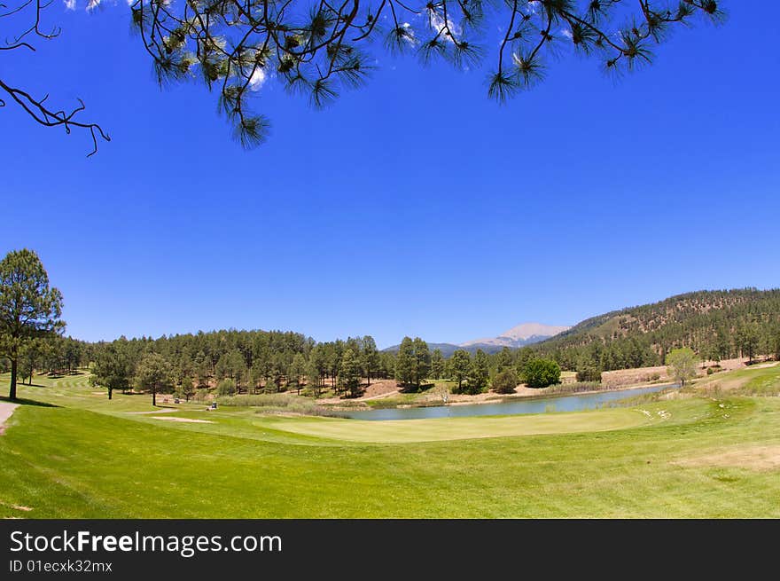 An image of a Arizona golf course with lush vegetation and mountain peaks. An image of a Arizona golf course with lush vegetation and mountain peaks