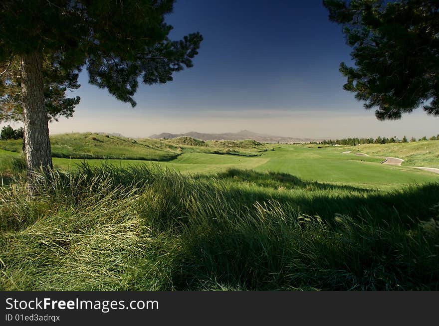 Golf fairway with blue sky