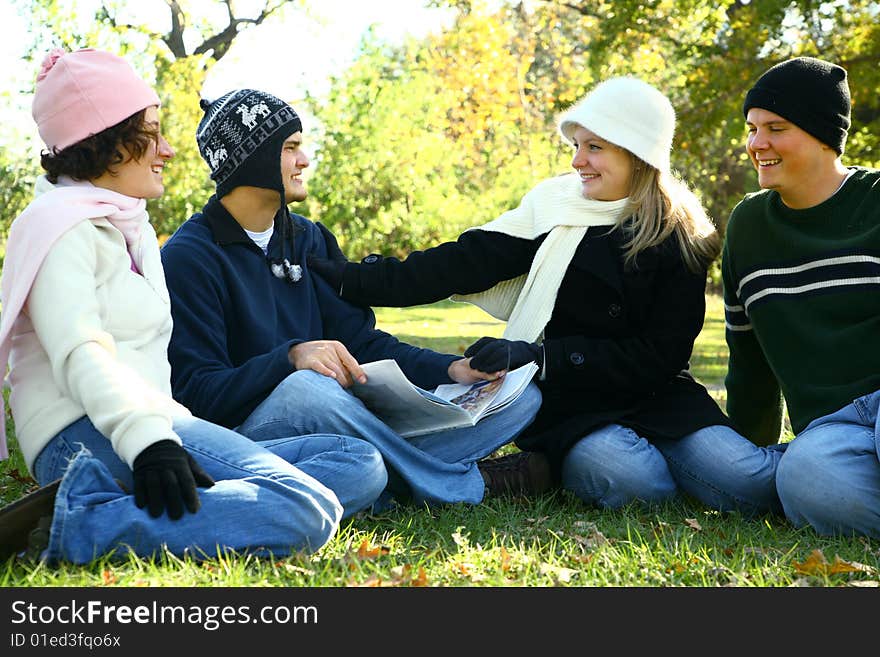 Four young caucasian male and female talking and having fun in park. Four young caucasian male and female talking and having fun in park