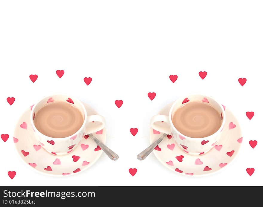 Shot of two cups of hot drink on white with hearts. Shot of two cups of hot drink on white with hearts