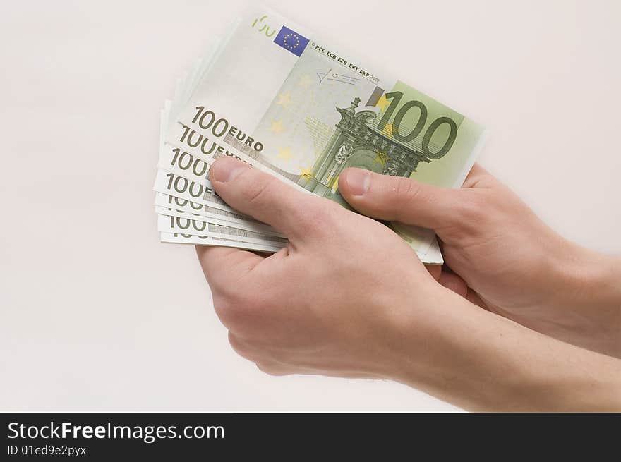 Male hands holding money (euro banknotes) isolated on white background. Male hands holding money (euro banknotes) isolated on white background