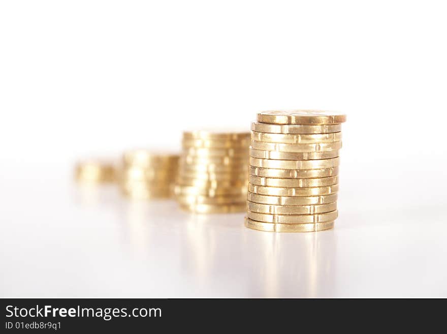 Stacked up coins. Coins are mirrored. Isolated over white. Ideal Businesshot. Stacked up coins. Coins are mirrored. Isolated over white. Ideal Businesshot.