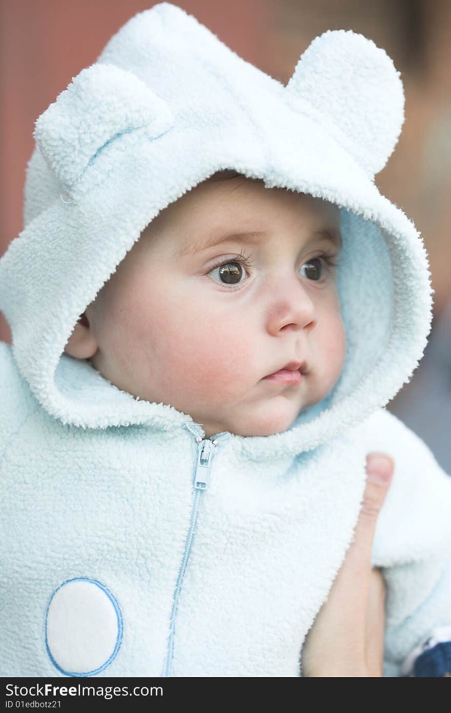 Close-up portrait of a cute child holding by his mother