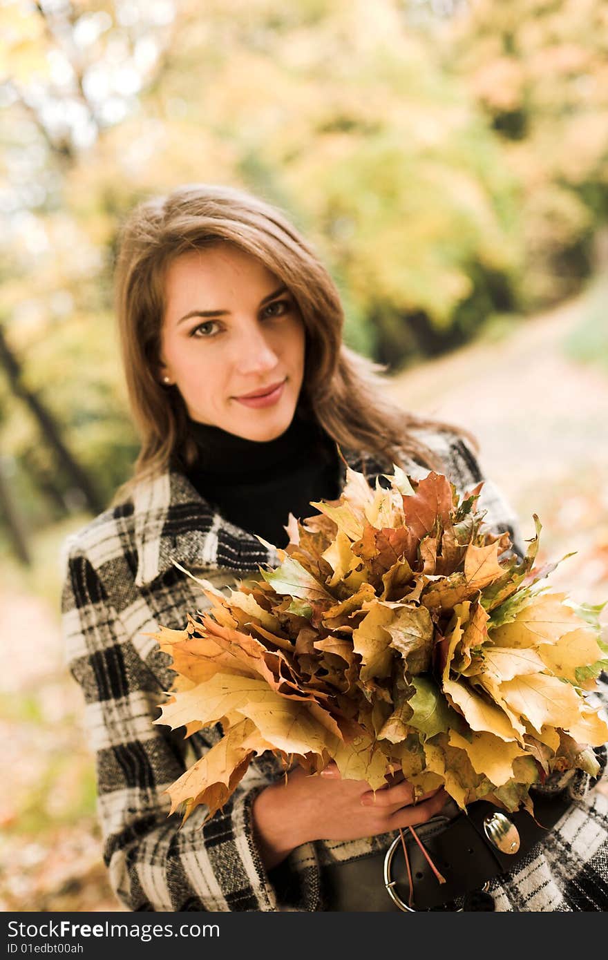 Young woman with a bouquet of maple leaves. Young woman with a bouquet of maple leaves