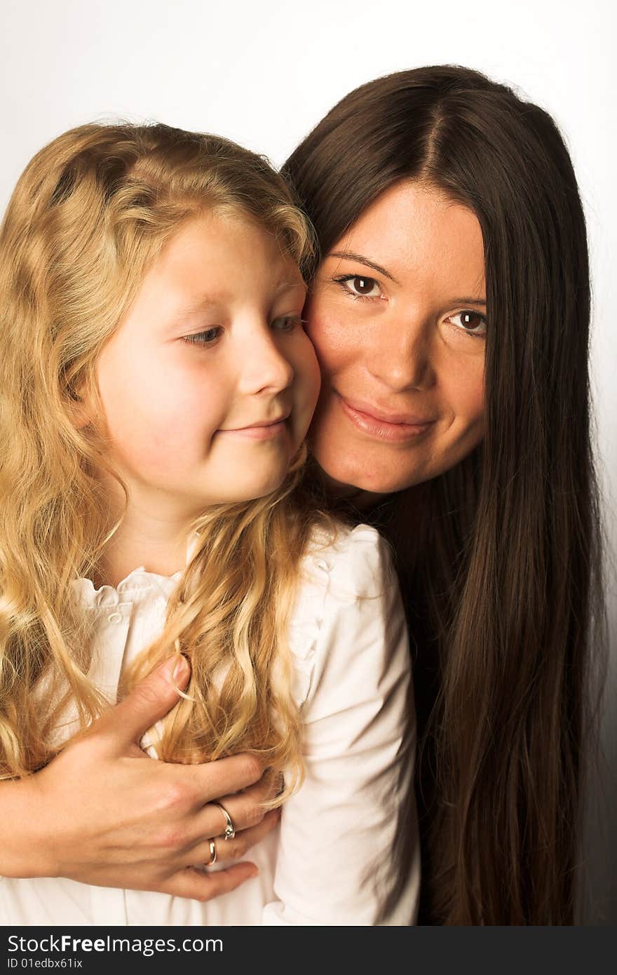 Young mother and daughter, studio shot,