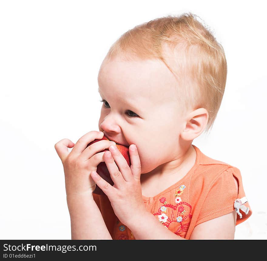 Studio portrait of a little girl eating an apple. Studio portrait of a little girl eating an apple