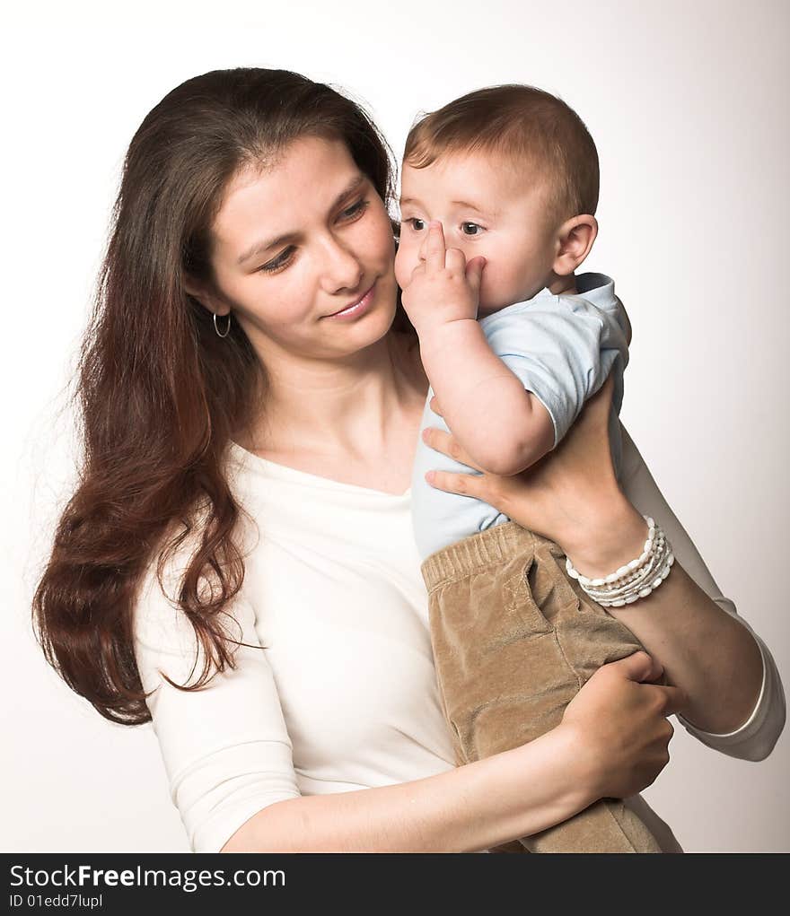 Studio portrait of a young mother with her child. Studio portrait of a young mother with her child